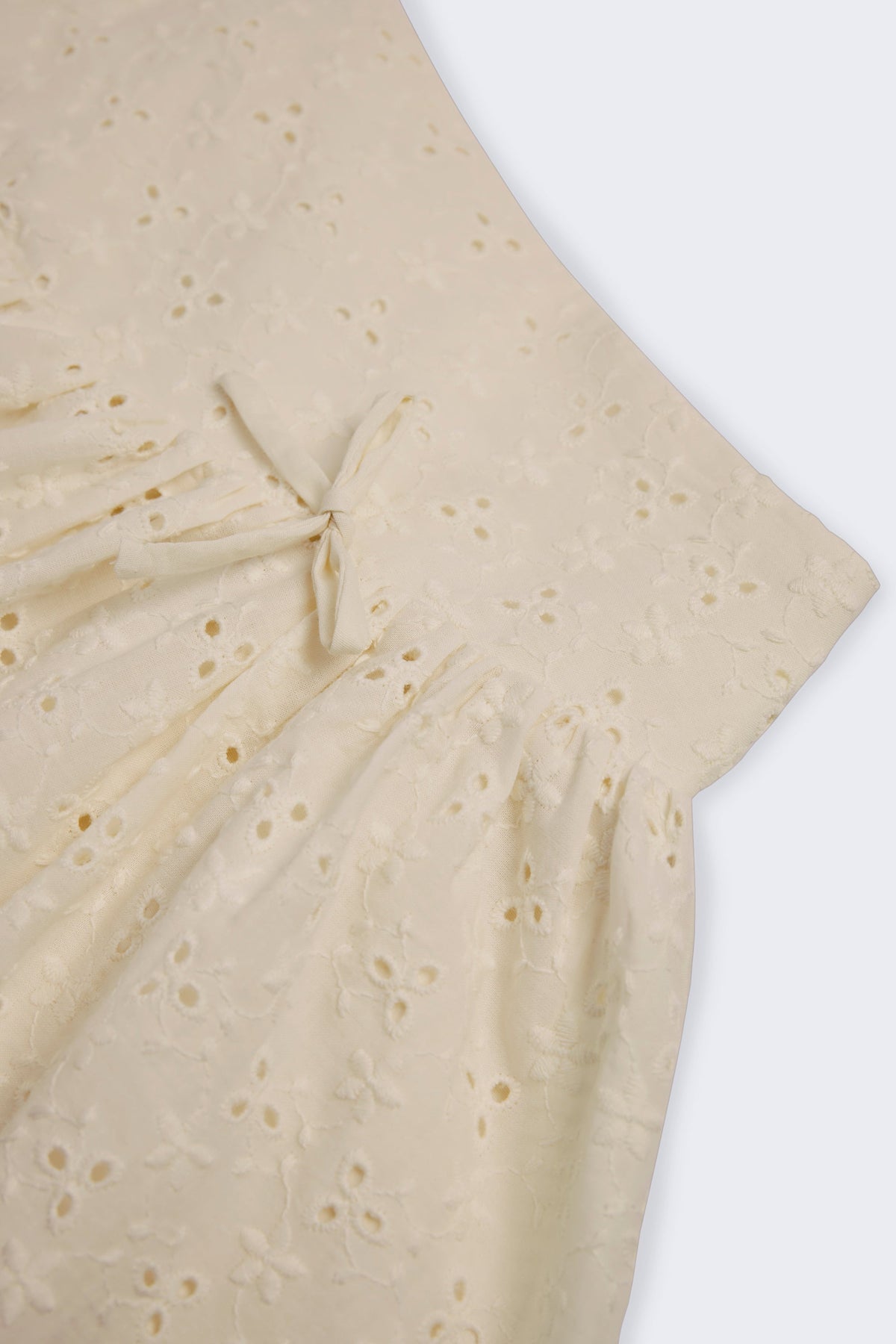 Chic Bow-Detail Broderie Anglaise Mini Skirt in Ivory