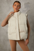 Chic Cropped Puffer Jacket with Detachable Sleeves in Sand